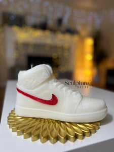 A stylish Nike Jordan 1 high-top shoe-inspired candle wax decor piece, perfect for trendy home accents and fashion-forward interior design. This limited edition collectible features iconic sneaker design elements, making it a unique and artistic statement piece. Ideal for enthusiasts of streetwear and exclusive releases, this decorative item adds flair to any space and makes for a distinctive and fashionable gift.