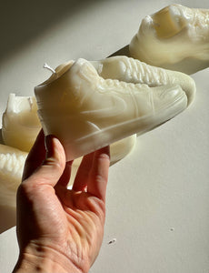 A stylish Nike Jordan 1 high-top shoe-inspired candle wax decor piece, perfect for trendy home accents and fashion-forward interior design. This limited edition collectible features iconic sneaker design elements, making it a unique and artistic statement piece. Ideal for enthusiasts of streetwear and exclusive releases, this decorative item adds flair to any space and makes for a distinctive and fashionable gift.