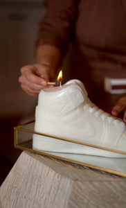 A stylish Nike Jordan 1 high-top shoe-inspired candle wax decor piece, perfect for trendy home accents and fashion-forward interior design. This limited edition collectible features iconic sneaker design elements, making it a unique and artistic statement piece. Ideal for enthusiasts of streetwear and exclusive releases, this decorative item adds flair to any space and makes for a distinctive and fashionable gift.